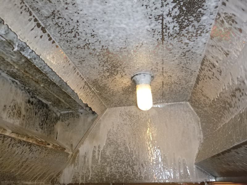 Foaming degreaser coating the inside of a kitchen exhaust hood in Hollywood, CA