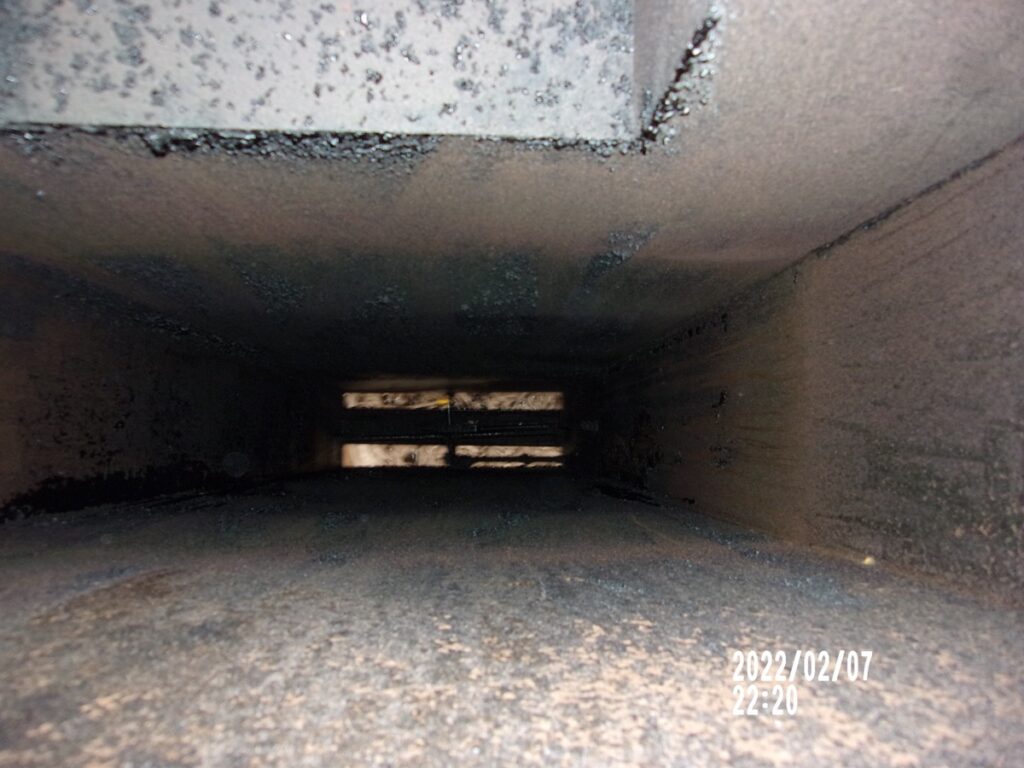 Greasy kitchen exhaust duct before professional cleaning in Burbank