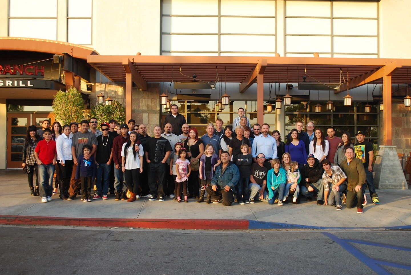 Group photo of Bryan Exhaust Service team outside a restaurant, showcasing camaraderie and teamwork, reflecting the company's commitment to quality kitchen exhaust cleaning services in Southern California.